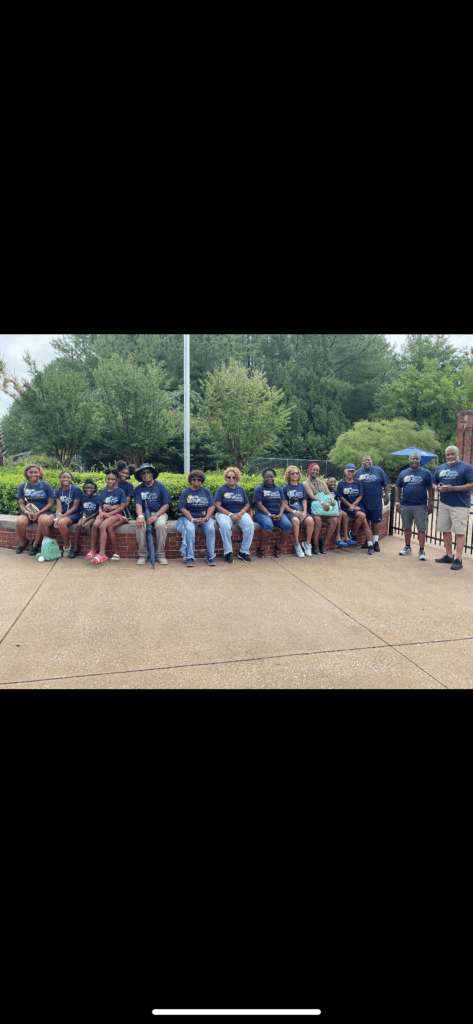 A Diverse Group of Individuals Seated on a Brick Wall