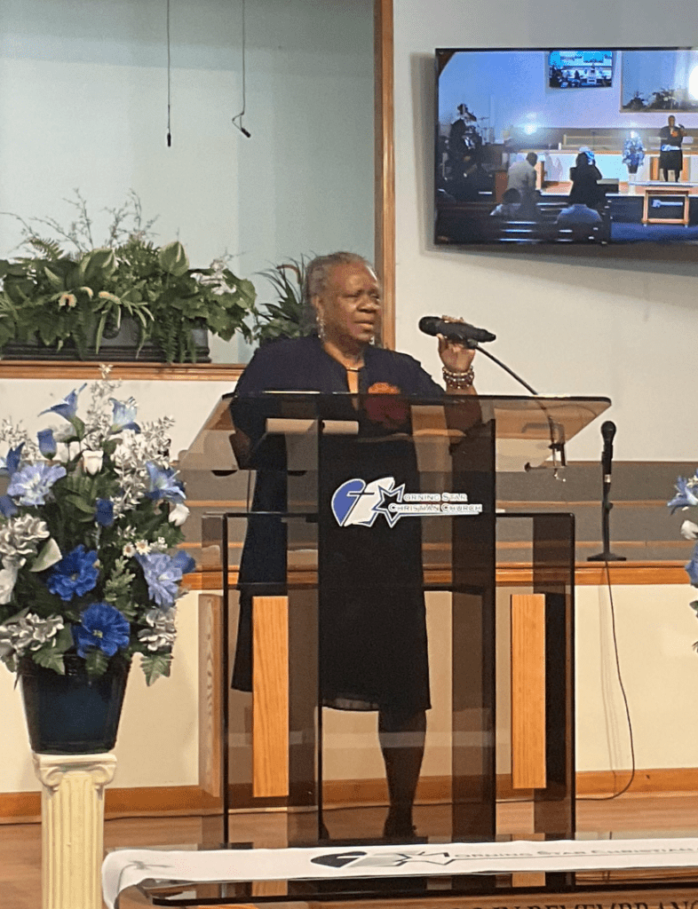 A Woman Delivers a Speech at a Podium