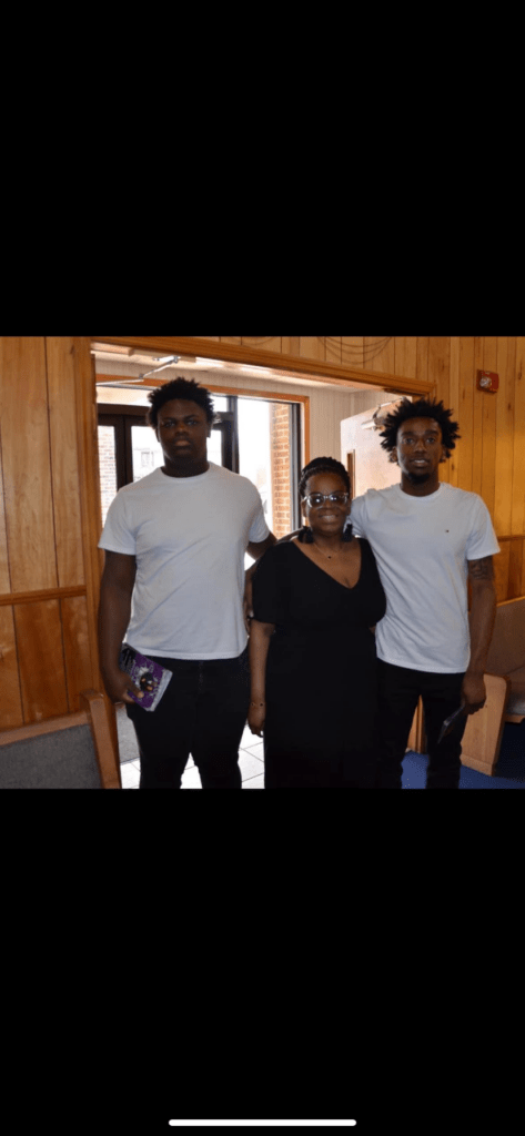 Three Individuals Stand Inside a Church